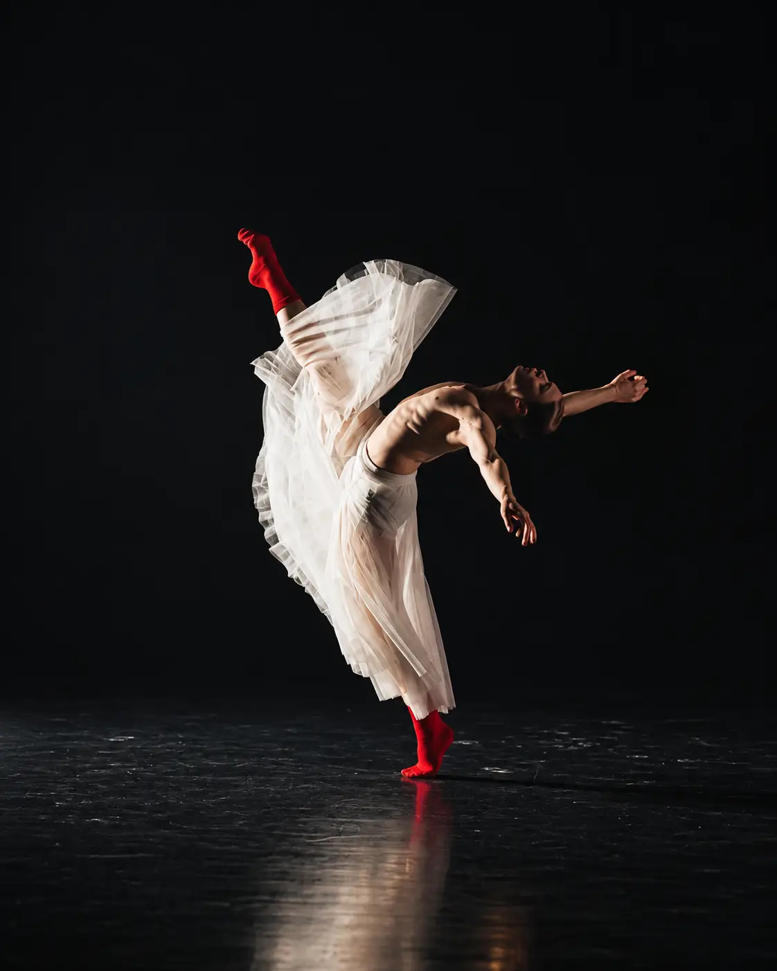 Stage dancers performing a dramatic partnered lift