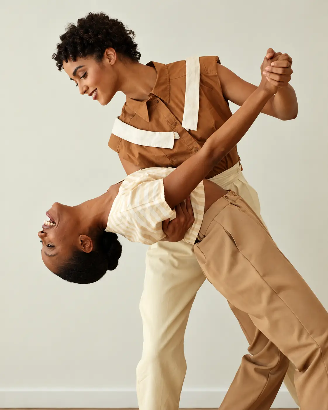 Ballroom duo in elegant formalwear preparing for an event