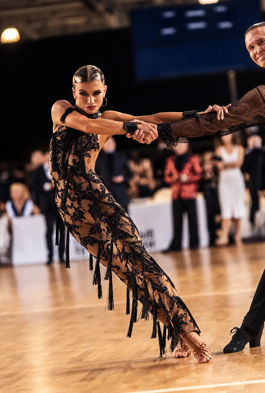Latin dancing performance under spotlights