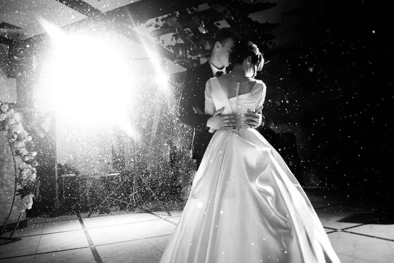 Wedding dance performers in a softly lit reception hall